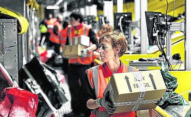 Imagen principal - Arriba, el ritmo de trabajo es intenso en las cuatro horas que concentran la entrada y salida de los aviones. En segundo lugar, arrastre y sujeción de cada posición en el interior del Airbus. En la tercera imagen vemos a Acron, cuyo olfato ha permitido detectar contenidos ‘opacos’.
