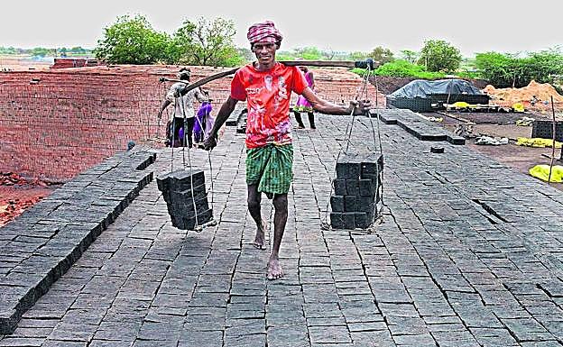 Un hombre traslada ladrillos en un horno de la India, el país donde más personas malviven en condiciones de servidumbre.