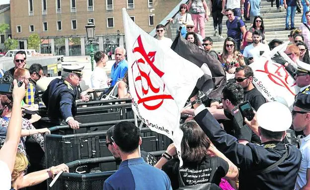 Un grupo de manifestantes protesta ante los tornos al grito de 'Venecia libre'.