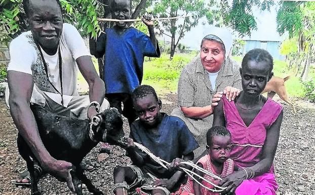 En la imagen una de las hermanas de las Marianitas junto a una familia turkana.