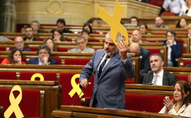 Carlos Carrizosa retira un lazo amarillo colocado en el banco del Govern.