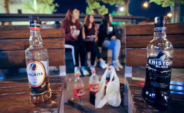 Grupo de jóvenes haciendo botellón.