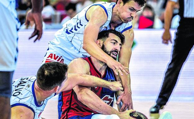 Shengelia trata de conservar el balón ante la oposición de dos jugadores del Gipuzkoa Basket.