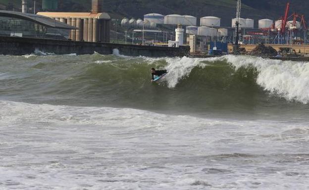 Un joven practica body board en la playa de Erega. 