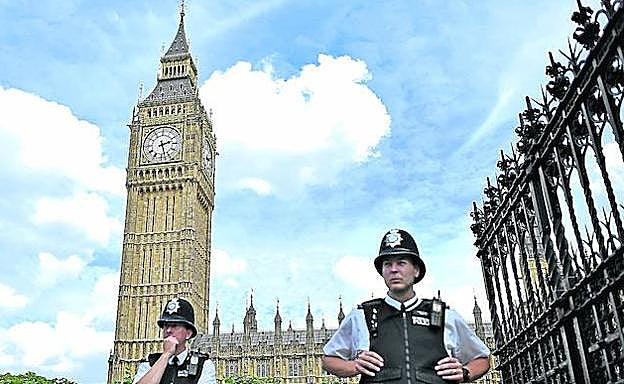 Dos agentes custodian los accesos al Parlamento británico; en el centro, el Big Ben.