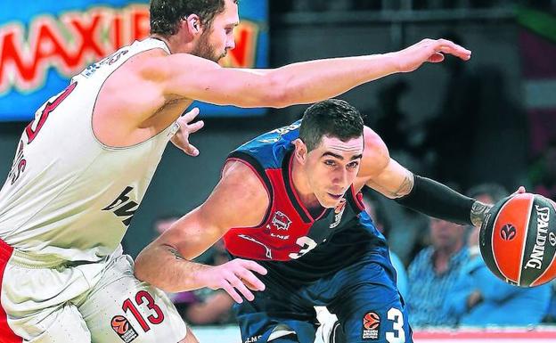 Luca Vildoza se escabulle de la presión de Janis Strelnieks en el reciente partido contra Olympiacos disputado en el Buesa Arena. 