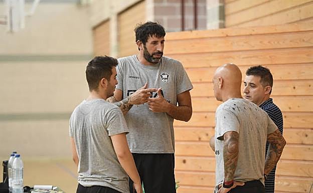Mumbrú charla con sus asistentes y el director deportivo, Rafa Pueyo, durante un entrenamkiento 