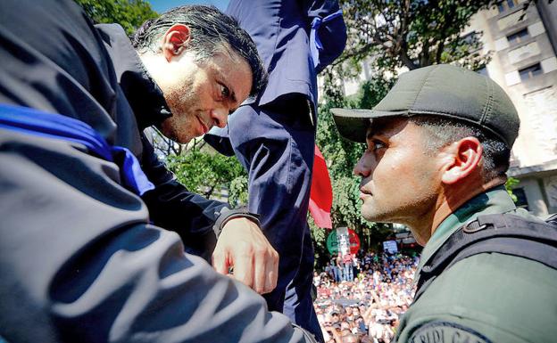 El opositor Leopoldo López habla con un soldado durante el mitin del martes en Caracas tras ser liberado de su arresto domiciliario. 