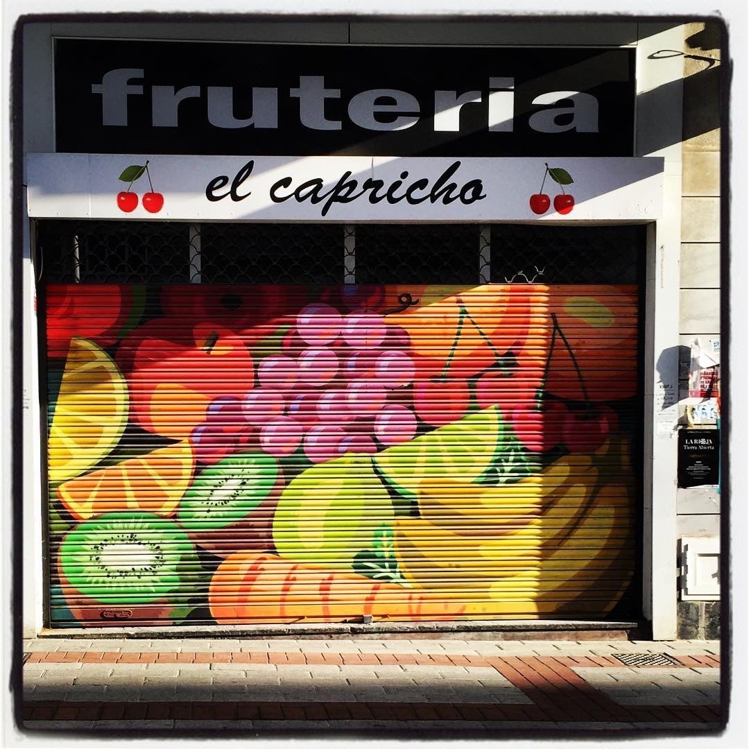 Diferentes frutas dan vida y color a esta persiana de una tienda de la calle Arana.