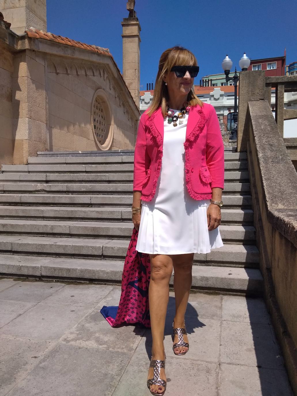 Asun Prieto (@asunportu) se decidió por un look en blanco. Su estilismo suma un precioso vestido y su chaqueta en rosa, reforzado por los complementos… El pañuelo y las sandalias, además del precioso collar de piedras. Un estilo chic y cargado de luz de verano.