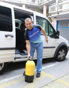 Imagen secundaria 2 - En la primera fotografía se puede ver el equipo que Iker Yraolagoitia y sus compañeros emplearán durante el buceo. En la segunda imagen el eibarrés revisa si la caja de herramientas imprescindible durante el buceo está a punto. En la última fotografía el guipuzcoano con la bombona que llevará durante el camino. 