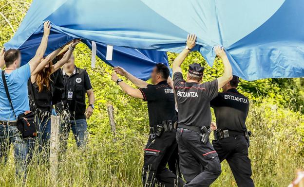 Ertzainas tapan el cadáver de Lösche, que apareció en Egino tras ser asesinada en Alemania.