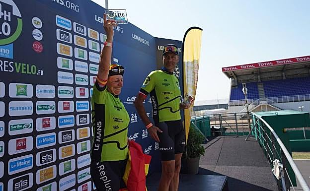 En lo más alto del podio en Le Mans, luciendo orgullosa la bandera y la placa entregada a modo de trofeo. 