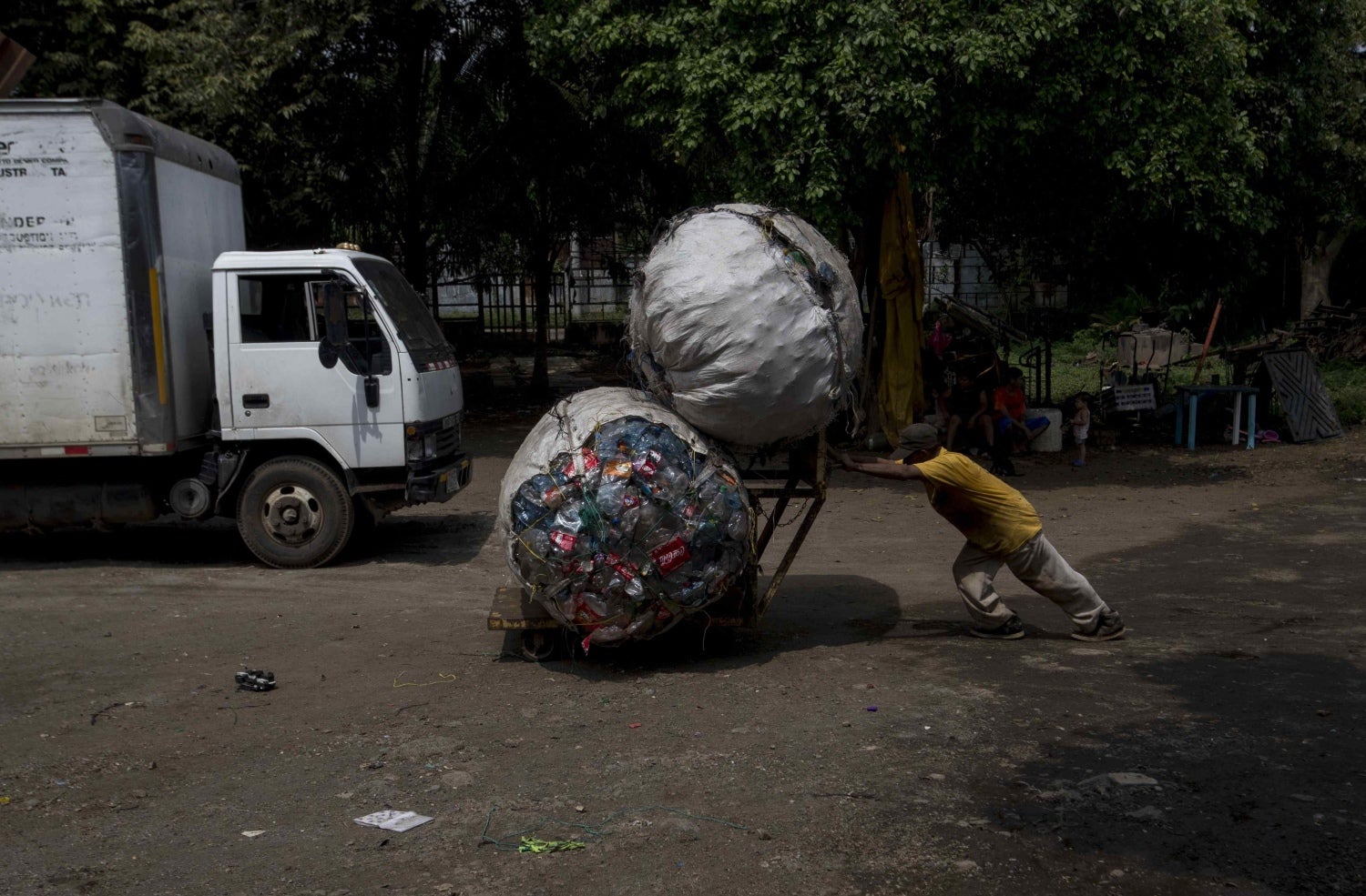 Un hombre empuja una carreta con dos pacas o cuatro quintales de plástico para vender, en Managua (Nicaragua). 