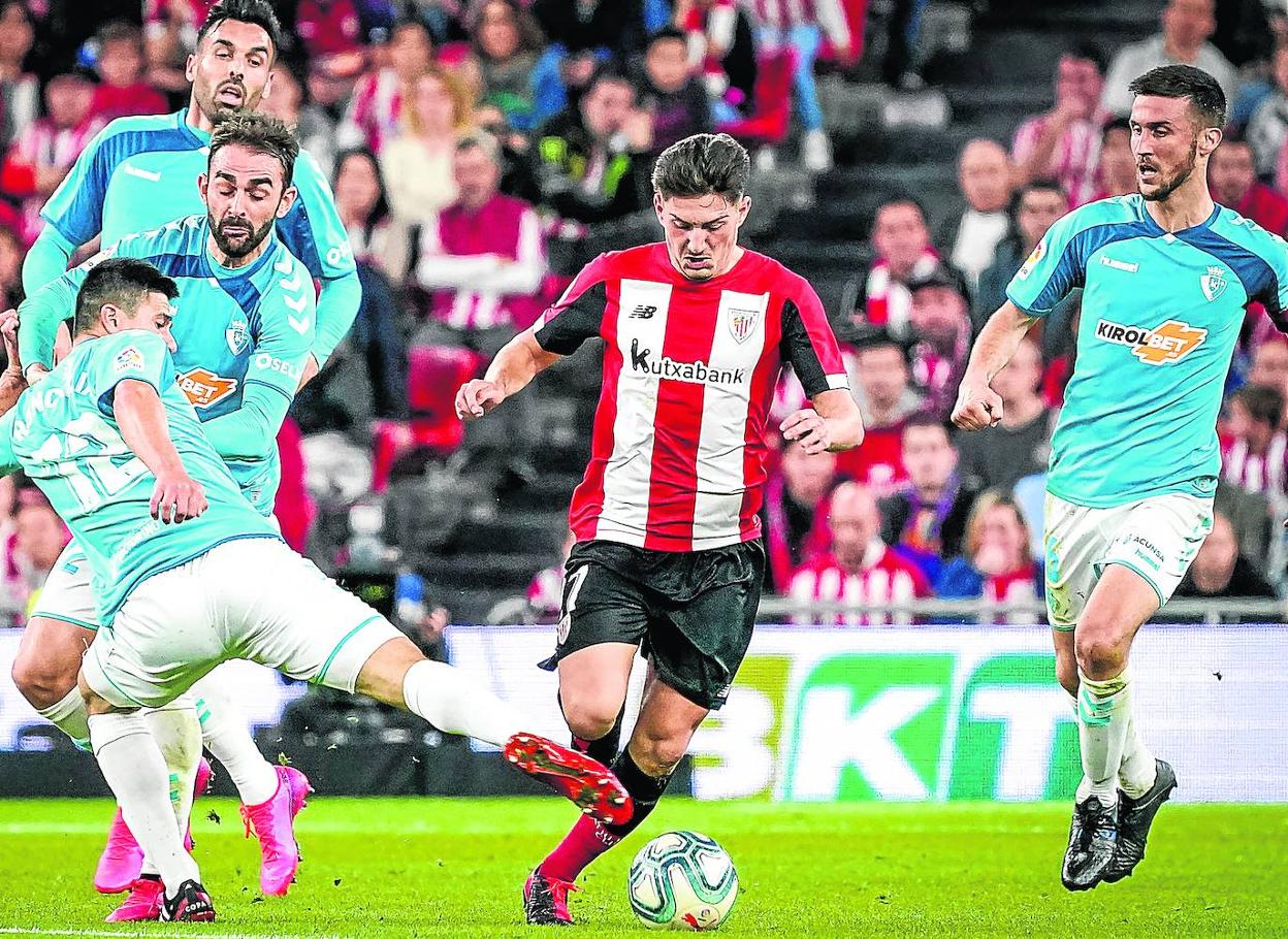 Unai Vencedor intenta regatear a Roncaglia rodeado de jugadores de Osasuna.