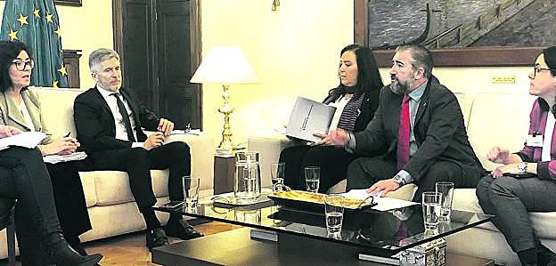 La subsecretaria de Interior, Isabel Goicoechea, y el ministro Fernando Grande Marlaska, con la delegación de la AVT en la reunión de ayer.