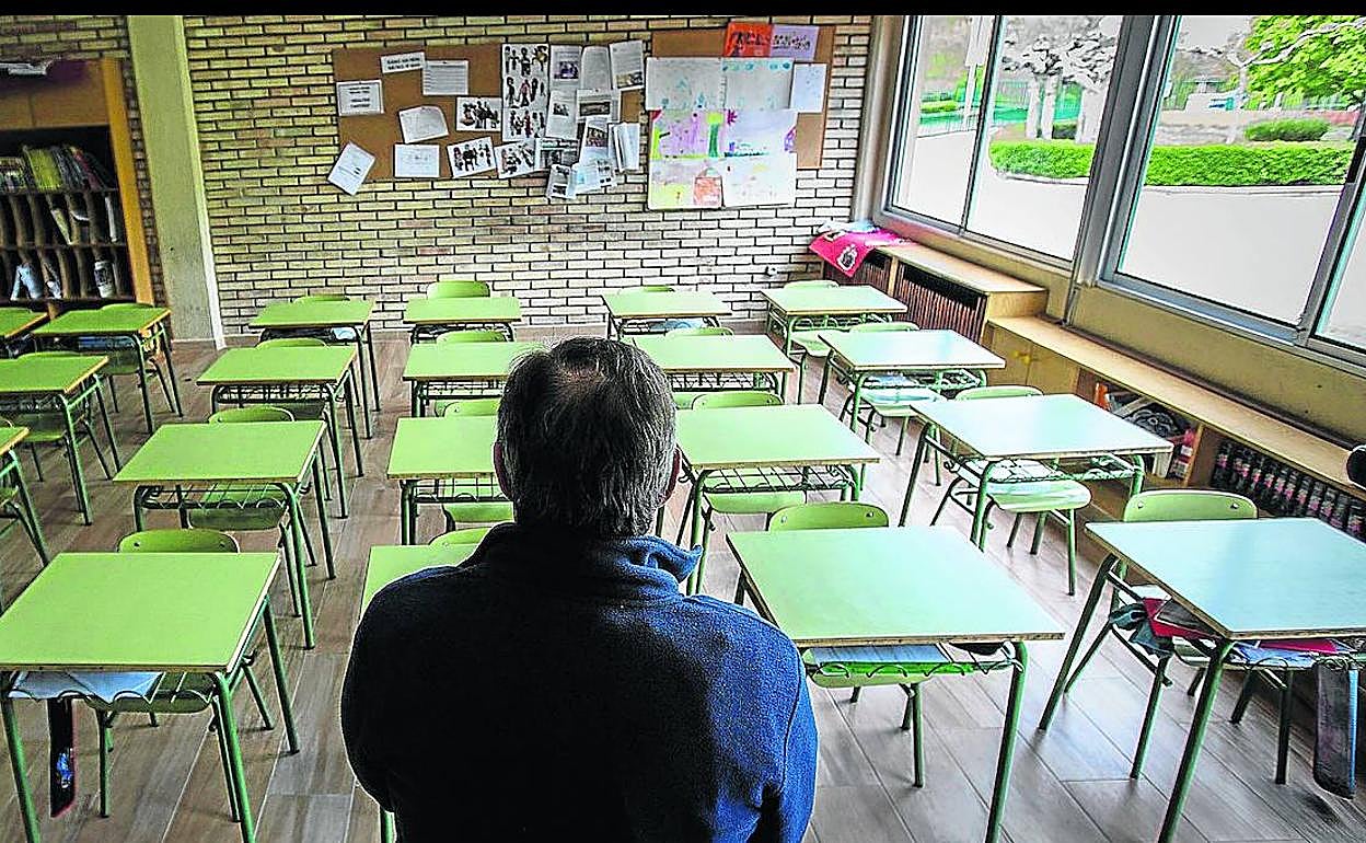 Un profesor permanece en un aula vacía de un centro de enseñanza en Aranda de Duero, en Burgos. 
