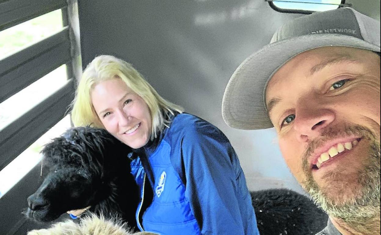 Adam Hayes y su esposa Brandy posan junto a dos alpacas en su hogar cercano a Charlotte.