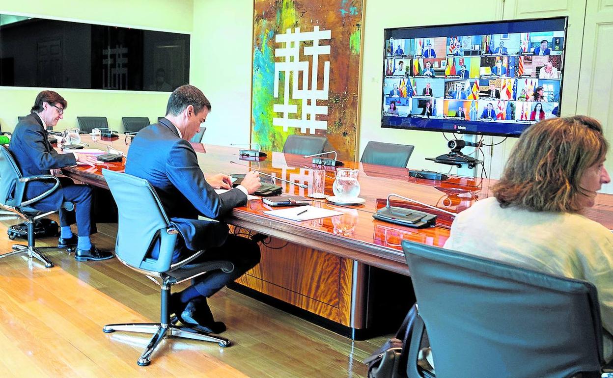 Pedro Sánchez, con los ministros Salvador Illa y Teresa Ribera, durante la Conferencia de Presidentes telemática mantenida ayer.