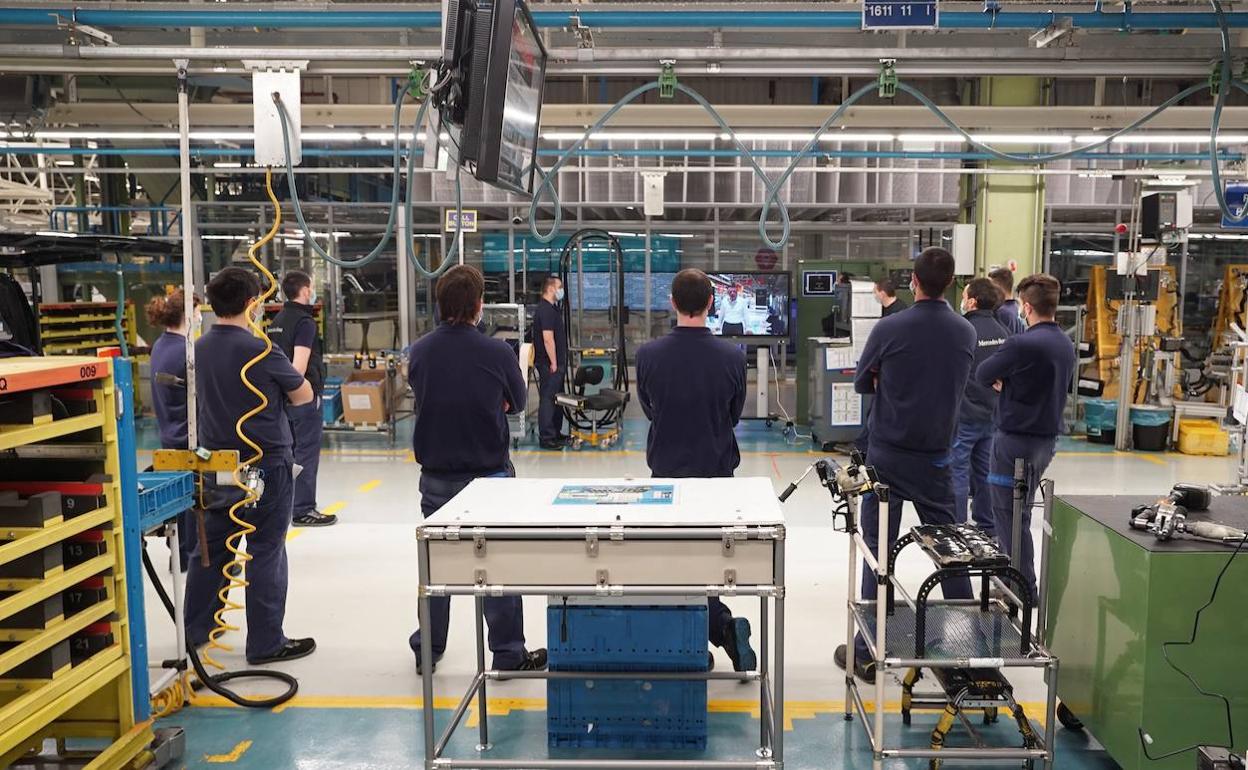 Trabajadores de la línea de montaje siguen una intervención grabada de Titos dirigiéndose a la plantilla cuando se retomó la producción.