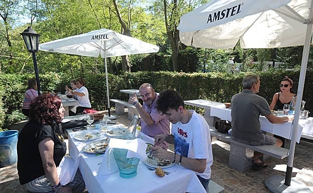 Los comensales disfrutan de la terraza arbolada del txakoli Ballano. 
