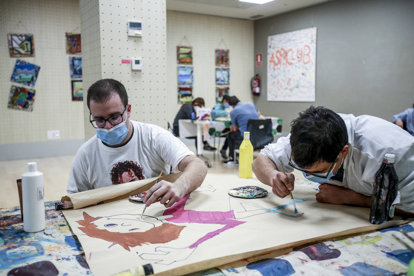 Usuarios y voluntarios participan en el taller de pintura de la asociación de parálisis cerebral Aspace, una de las numerosas actividades de las que disfrutan sus más de 130 miembros.