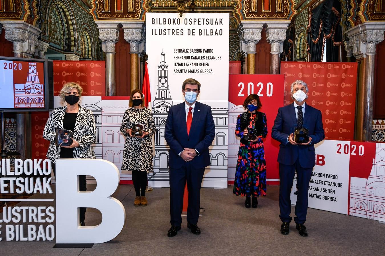 El alcalde y los cuatro homenajeados, en el acto.