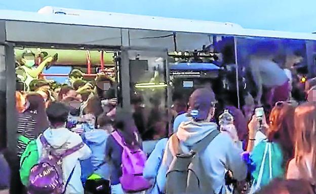 Sin distancia de seguridad. Decenas de jóvenes tratan de acceder a uno de los autobuses, ya abarrotado, de la lanzadera de Metro Bilbao. 