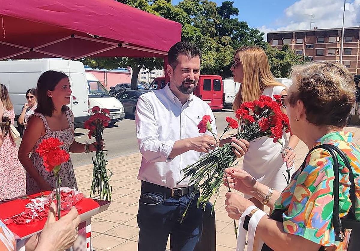 Luis Tudanca repartiendo claveles junto a Esther Peña y Aitana Hernando.