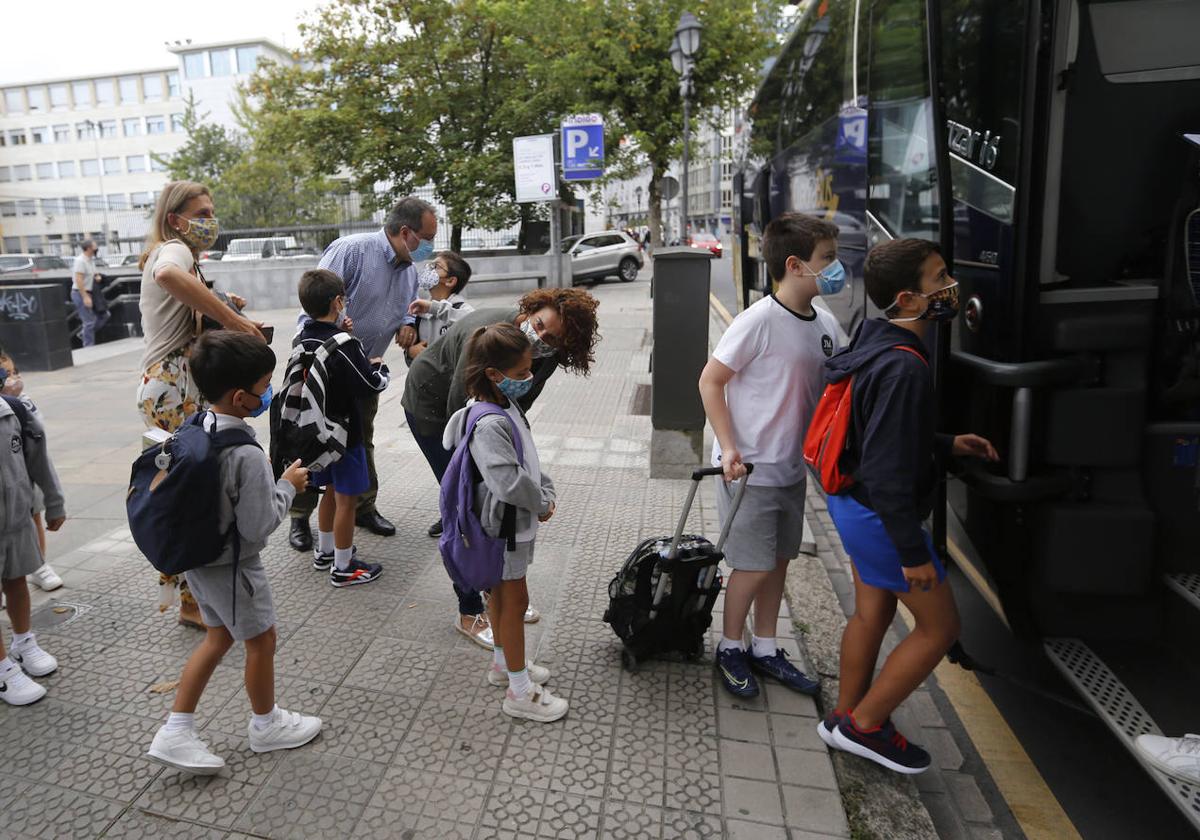 Niños subiendo a un autobus escolar.