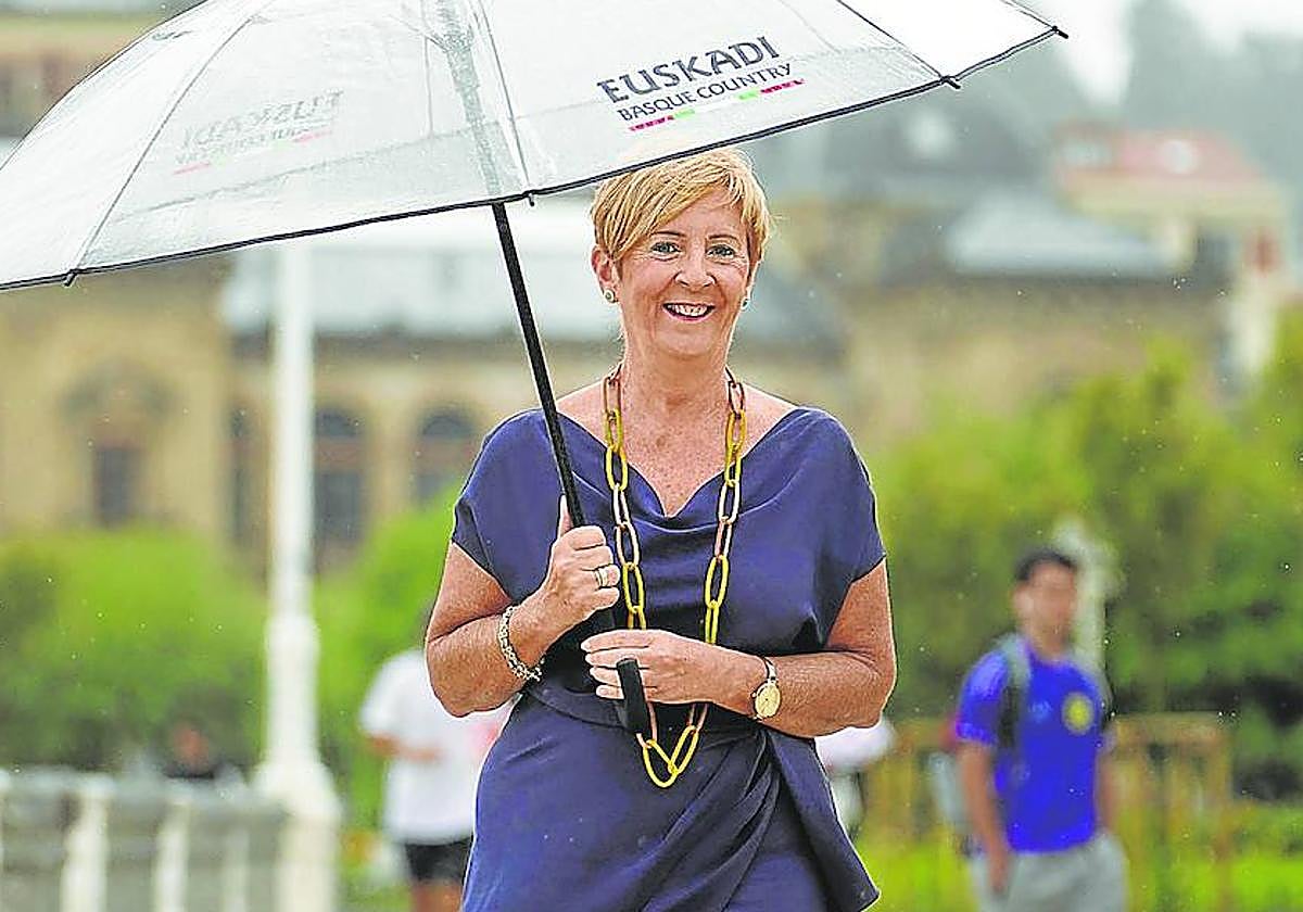 La consejera Arantxa Tapia se resguarda de la lluvia en el paseo de La Concha, el pasado jueves, en pleno chaparrón.