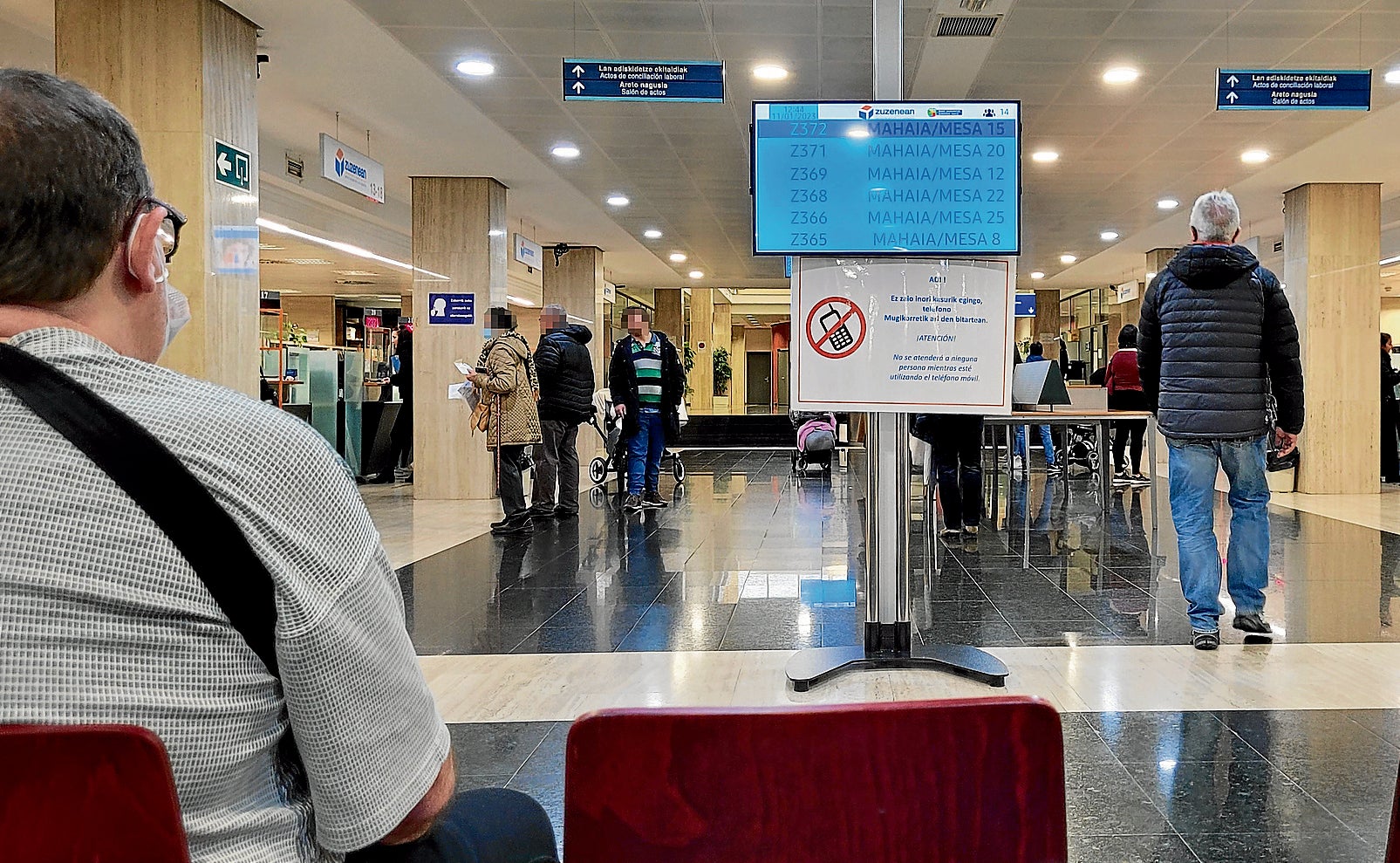 Varios ciudadanos esperan a ser atendidos en unas dependencias del Gobierno vasco en Bilbao.