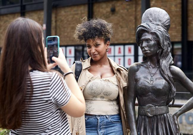 Unas admiradoras se fotografían junto al busto de la cantante.