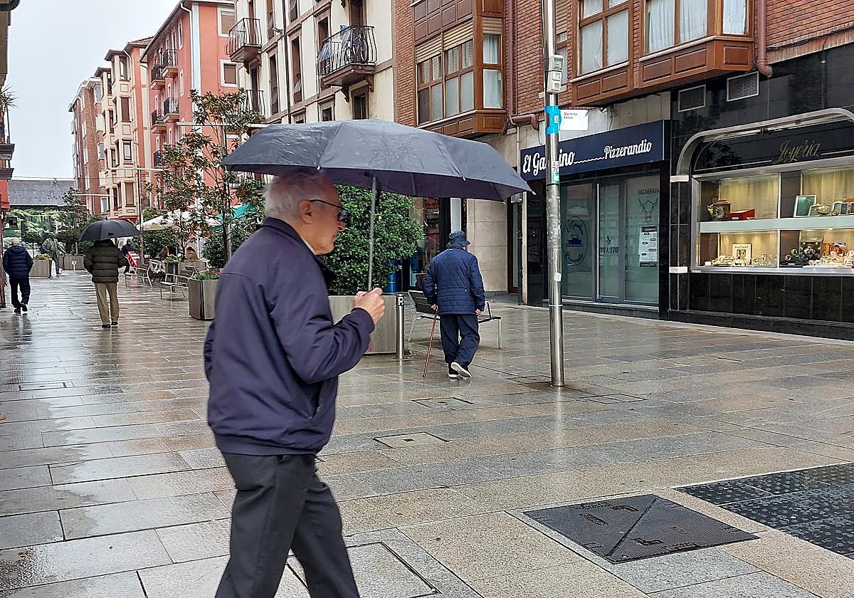 Personas mayores pasean por el centro del municipio.