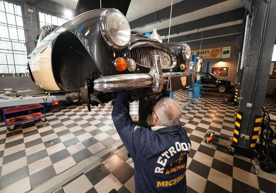 Uno de los mecánicos de Retromobile trabaja en un Austin-Healey.