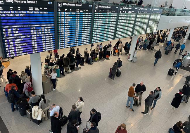 Pasajeros hacen una larga cola en el aeropuerto de Munich.