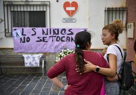 Vecinas de Abla (Almería) colocan flores en la puerta del colegio donde estudiaban las niñas presuntamente asesinadas por su padre.