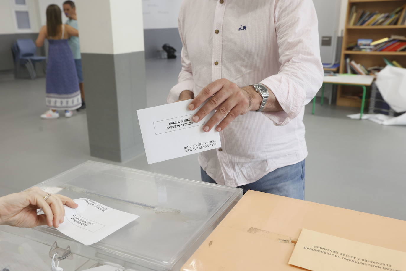 Un votante se dispone a depositar su papeleta.