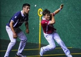 Fernández, de colorado, golpea una pelota ante la mirada de Oskoz.