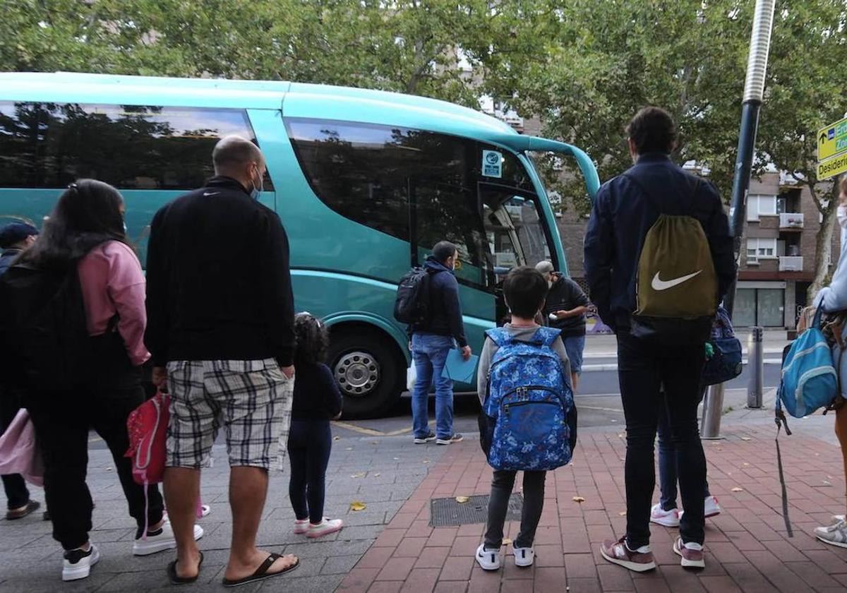 Escolares aguardan al autobús escola.