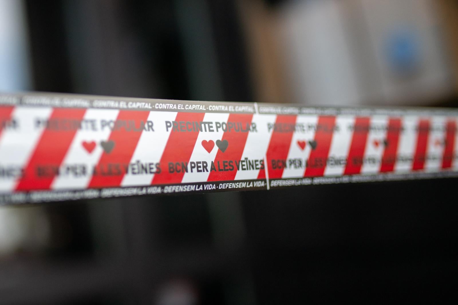 Una cinta de protesta con el lema 'Precinto Popular, Barcelona para los vecinos'.