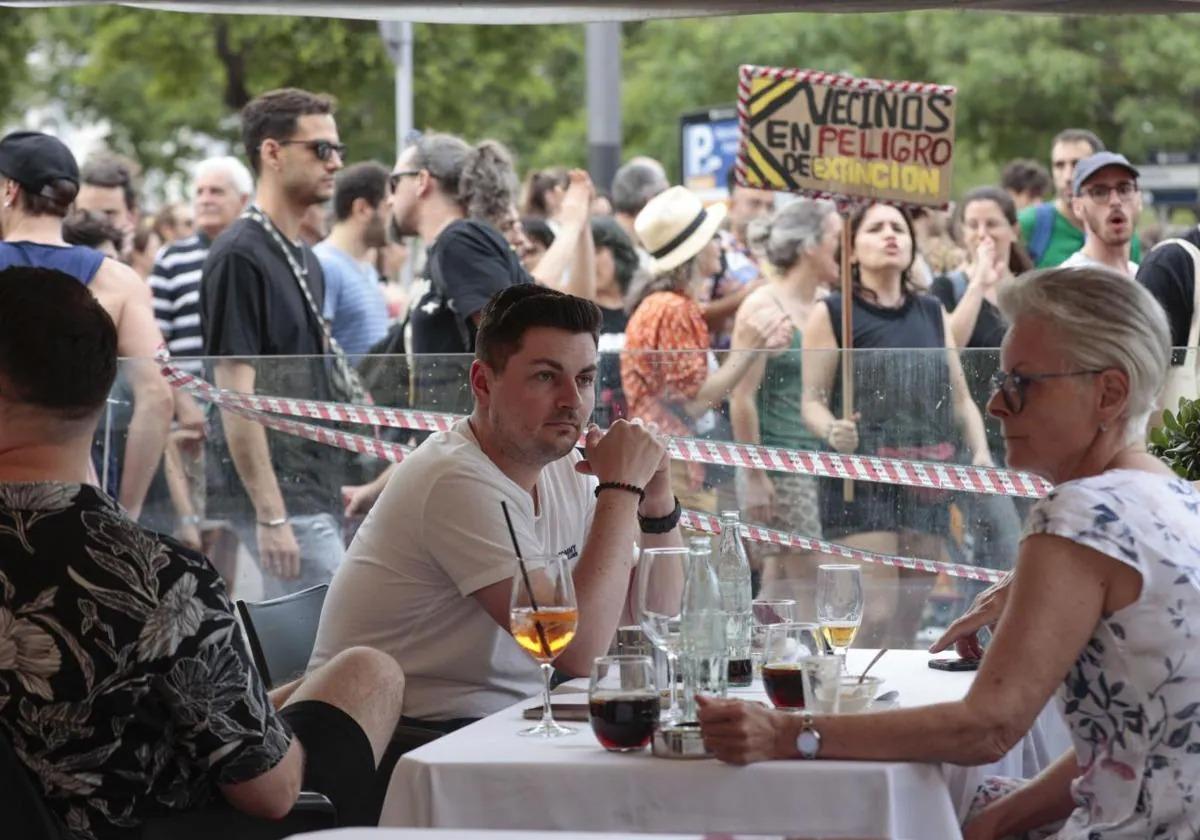 Manifestantes de Barcelona en plena protesta ante los turistas comiendo en las terrazas.