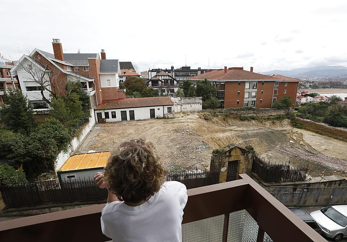 Una vecina contempla el solar dejado por el derribo de un palacete protegido en Getxo.