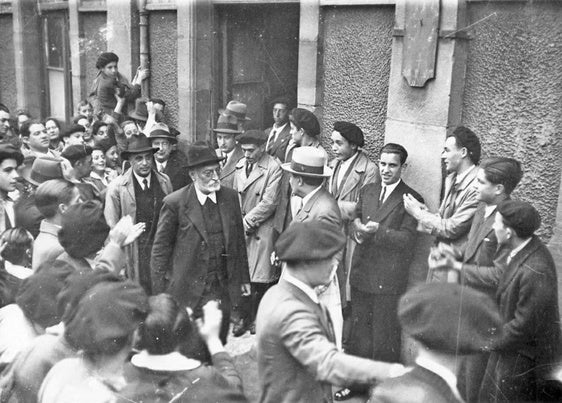 Miguel de Unamuno, aplaudido al salir de una portal en la Calle Nueva de Bilbao.