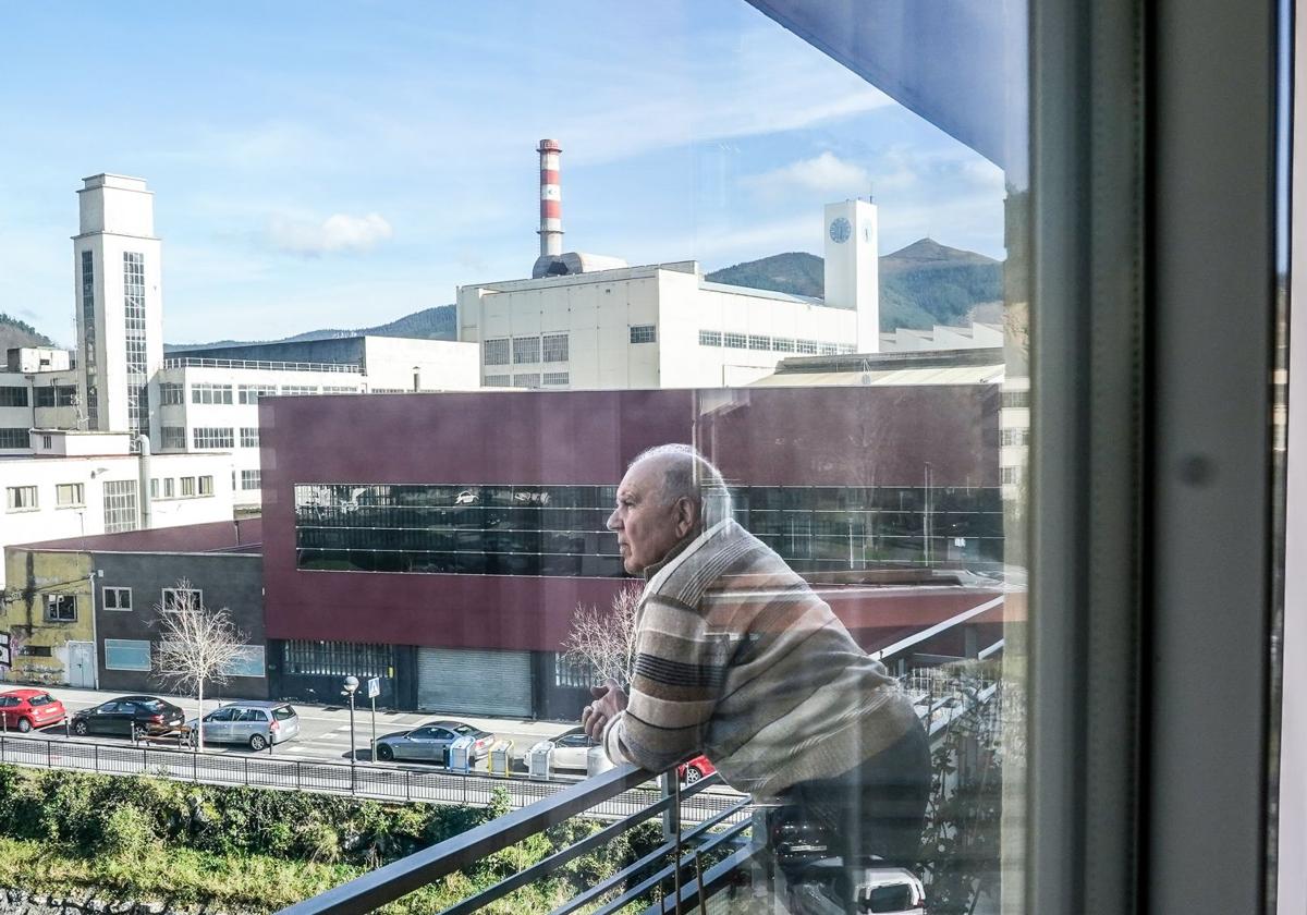 Javier Barañano, jubilado de Guardian, observa la fábrica desde el balcón de su casa.