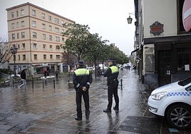 Policías locales vigilan en la calle donde se produjo el segundo robo con violencia de ayer, domingo.