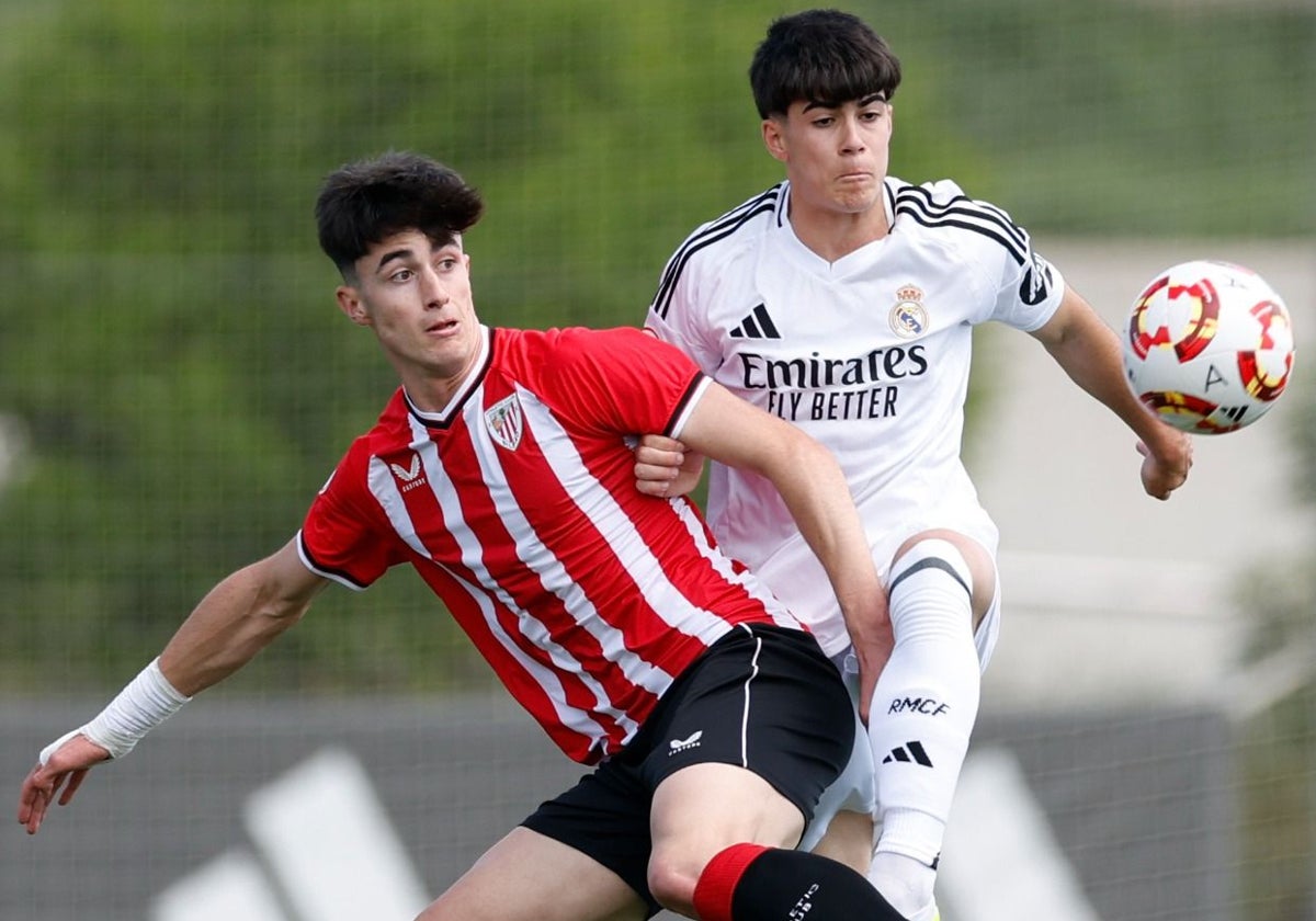 Manex Lozano pugna por un balón con un jugador del Real Madrid.