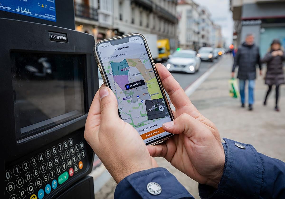 Una persona paga la OTA en Vitoria a traves de la aplicación móvil.