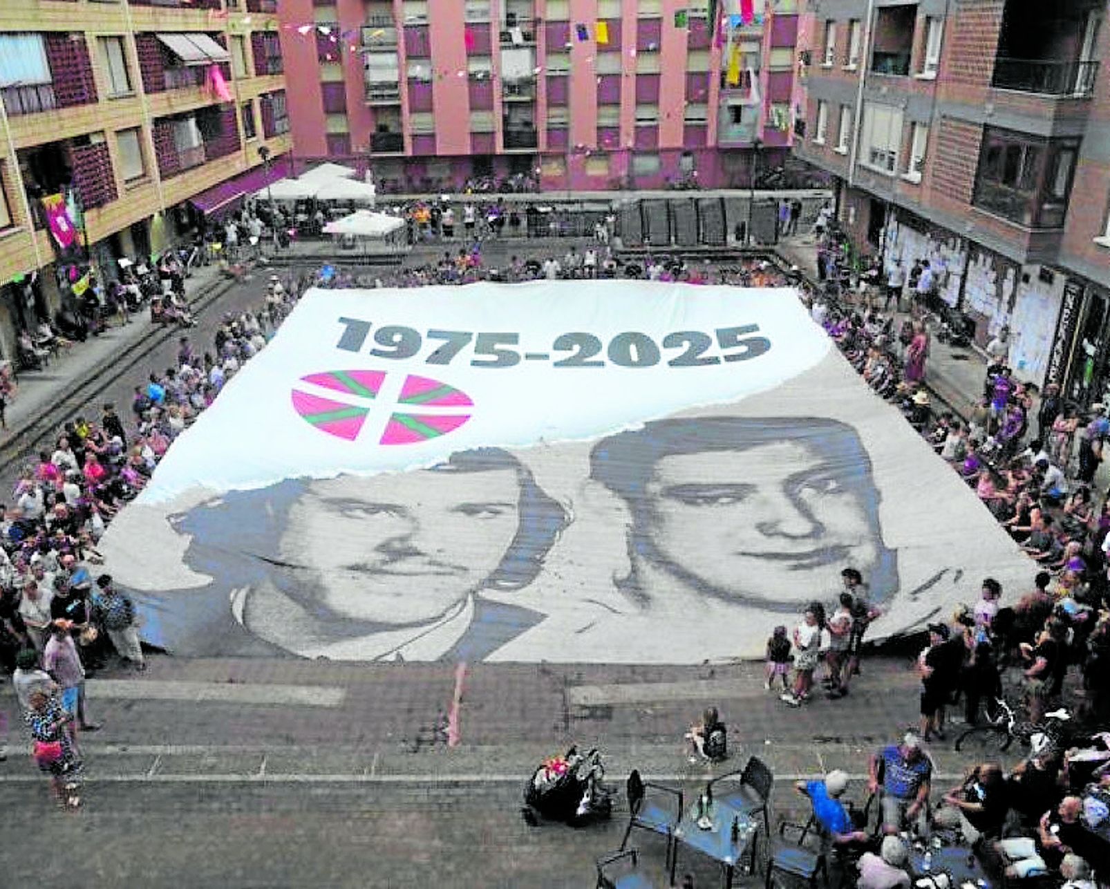 Vecinos de Zarautz desplegaron el martes en una de sus plazas la lona con los rostros de 'Txiki' y Otaegi.