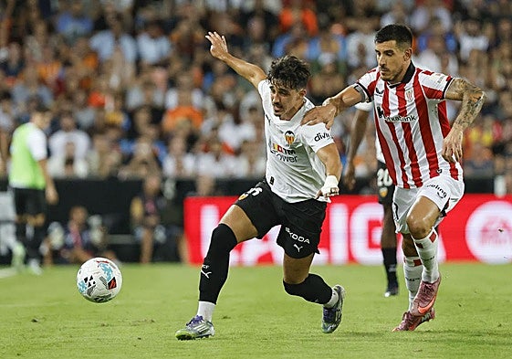 Yuri trata de frenar a Diego López.